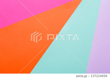 Brightly colored paper in shades of pink, orange, teal, and purple forms an abstract arrangement. The geometric shapes create a lively backdrop that adds visual interest to any project. Brightly colored paper in shades of pink, orange, teal, and purple forms an abstract arrangement. The geometric shapes create a lively backdrop that adds visual interest to any project. 137224856