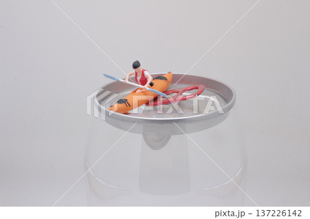 Miniature Kayak Figure Paddles Across Raised Circular Platform Miniature Kayak Figure Paddles Across Raised Circular Platform 137226142