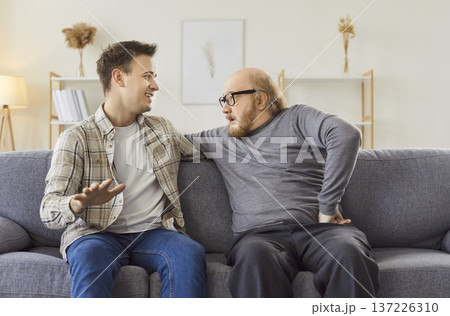 Cheerful Son And Senior Father Conversing At Home Cheerful Son And Senior Father Conversing At Home 137226310