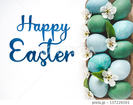 Happy Easter. Pastel blue Easter eggs and congratulatory text Happy Easter. Pastel blue Easter eggs and congratulatory text 137226501