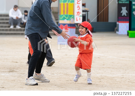 運動会で親子競技をする幼児と父親 137227255