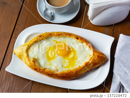 Khachapuri in Adjarian. Open pies with mozzarella and egg. Khachapuri in Adjarian. Open pies with mozzarella and egg. 137228472