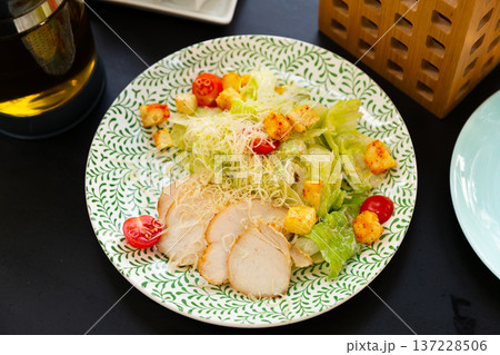 Chicken Caesar salad with tomatoes and cheese Chicken Caesar salad with tomatoes and cheese 137228506