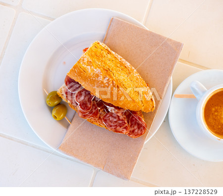 Sandwich with delicious delicaty dried sausage Fuet Sandwich with delicious delicaty dried sausage Fuet 137228529