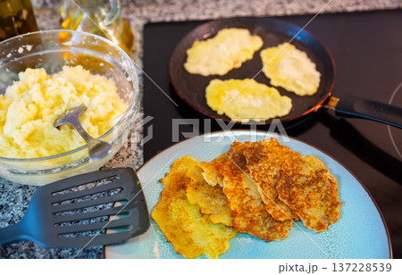 Preparation of potato pancakes on frying pan Preparation of potato pancakes on frying pan 137228539