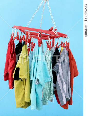 Colorful baby Clothes Hanging on Plastic Clip Hanger Colorful baby Clothes Hanging on Plastic Clip Hanger 137229283