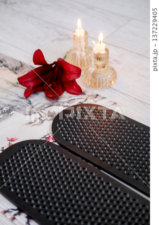 Sadhu board. Yoga tool. Sharp nails for practice calming meditation training foot massage developing spiritual growth flower candles placed on floor. Sadhu board. Yoga tool. Sharp nails for practice calming meditation training foot massage developing spiritual growth flower candles placed on floor. 137229405