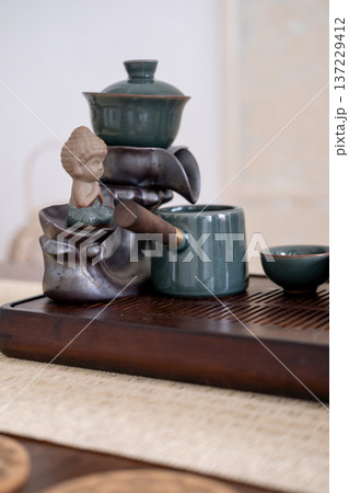 Tea service. Fresh beverage. Table with tea-board pouring water chinese ceramics spiritual ceremony for drinking figurine. 137229412
