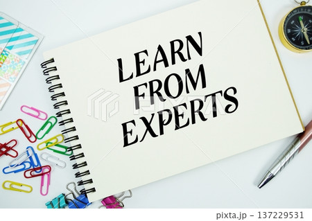 Learn From Experts text message written on notepad with stationery flat lay on white background Learn From Experts text message written on notepad with stationery flat lay on white background 137229531