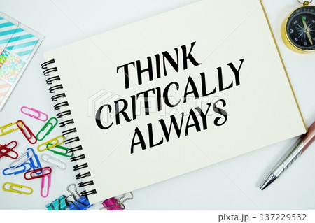 Think Critically Always text message written on notepad with stationery flat lay on white background 137229532