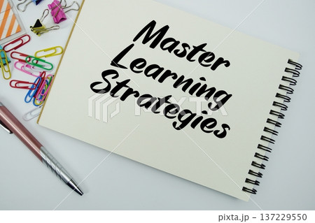 Master Learning Strategies text message written on notepad with stationery flat lay on white background 137229550