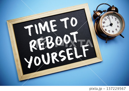 Time To Reboot Yourself text on Blackboard and alarm clock on blue background 137229567
