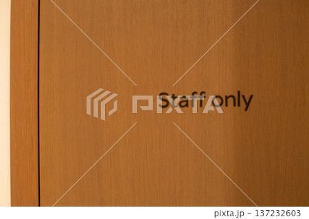 Staff only sign on wooden panel. Designated area for employees only. Fenced off area where unauthorized access is prohibited. Confidential information for employees. Business discussion with workers Staff only sign on wooden panel. Designated area for employees only. Fenced off area where unauthorized access is prohibited. Confidential information for employees. Business discussion with workers 137232603