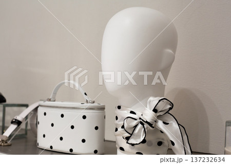Timeless classic on store shelf. White with black dots on necktie and handbag. Combination of white and black polka dots. Dots on white textiles. Shopping in store with polka dot pattern Timeless classic on store shelf. White with black dots on necktie and handbag. Combination of white and black polka dots. Dots on white textiles. Shopping in store with polka dot pattern 137232634