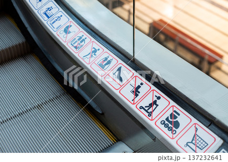 Escalator accidents. Dangers of moving structures on escalators. Possibility of things getting caught in cracks of escalator. Prevent injuries on escalators by following rules 137232641