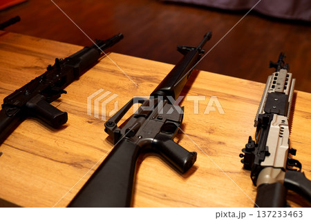 Rifle on school desk after shooting. Concept of armed attack on college and university. Mental health issues in child who opened fire at school. Terrorist attack on educational institution Rifle on school desk after shooting. Concept of armed attack on college and university. Mental health issues in child who opened fire at school. Terrorist attack on educational institution 137233463