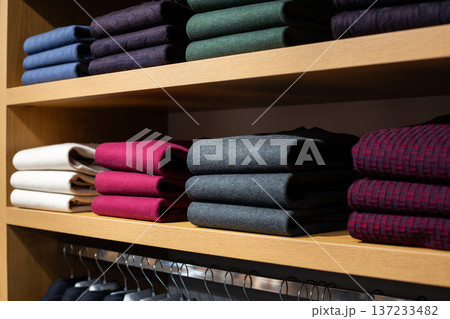 Warm sweaters for staying warm in office in cold weather. Clothing for unheated office. Solution for offices where workers are freezing. Warm classic clothing for men on shelves of business store 137233482