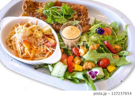 Die cut of Vegetable salad fried sea bass and papaya salad on white isolated. Die cut of Vegetable salad fried sea bass and papaya salad on white isolated. 137237654