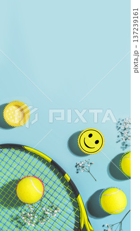 Tennis Racket With Yellow Balls And Smiley Sticker On Blue Background 137239161