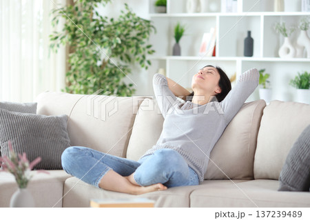 Asian woman relaxing and resting sitting in a comfortable sofa 137239489
