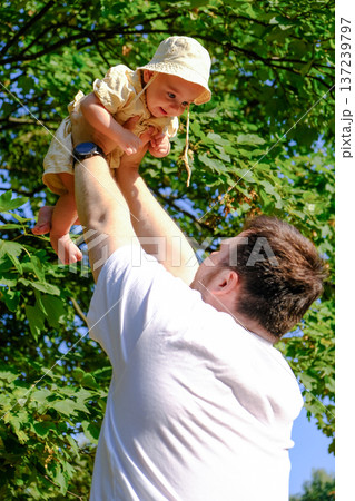 Father and Baby Enjoying a Sunny Day in the Park Father and Baby Enjoying a Sunny Day in the Park 137239797