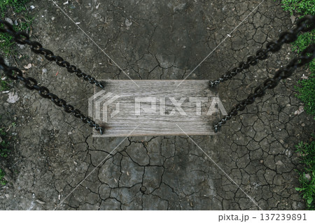 Lonely Wooden Swing Over Cracked Earth in Dark Melancholic Atmosphere Lonely Wooden Swing Over Cracked Earth in Dark Melancholic Atmosphere 137239891
