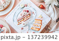 embroidery pattern book with beautifully embroidered food, such as cake and ice cream, on the pages of an open white fabric cloth in pastel colors. 137239942