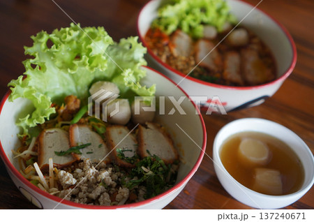 Traditional Sukhothai Tom Yum Rice Noodles with Sliced Long Beans, Red Pork, and Soft-Boiled Egg Traditional Sukhothai Tom Yum Rice Noodles with Sliced Long Beans, Red Pork, and Soft-Boiled Egg 137240671