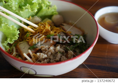 Traditional Sukhothai Tom Yum Rice Noodles with Sliced Long Beans, Red Pork, and Soft-Boiled Egg Traditional Sukhothai Tom Yum Rice Noodles with Sliced Long Beans, Red Pork, and Soft-Boiled Egg 137240672