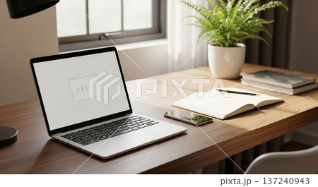 木製デスク上の携帯型計算機と業務資料表示画面の室内風景 137240943