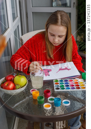Preteen kid drawing. Cute child at home Preteen kid drawing. Cute child at home 137241335