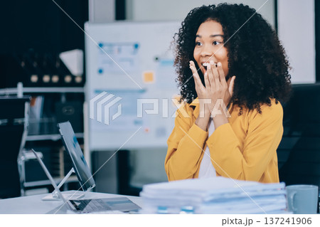Pretty female freelancer working on laptop while sitting on modern coworking background Pretty female freelancer working on laptop while sitting on modern coworking background 137241906