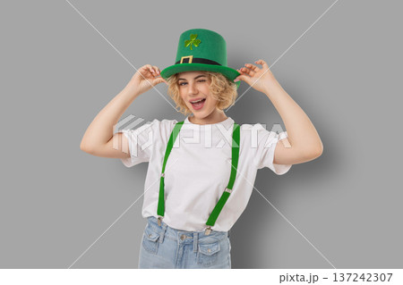 A woman wears a green hat and smiles for St Patrick's Day 137242307