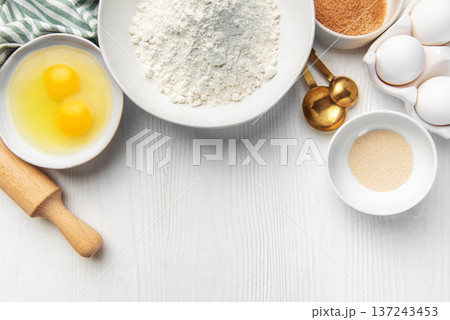 Baking ingredients on white wooden table for food preparation Baking ingredients on white wooden table for food preparation 137243453