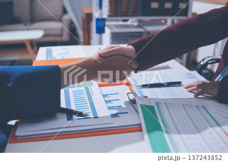 Two smiling business men shaking hands together after successful meeting. Two smiling business men shaking hands together after successful meeting. 137243852