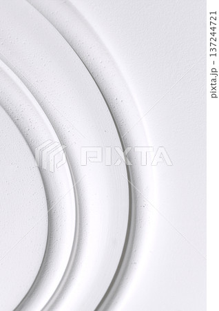 Decorative item made of white plaster on ceiling close-up. Relief stucco interior 137244721