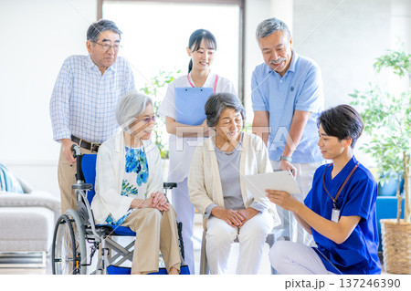車椅子に乗る高齢者と介護士の男女 137246390
