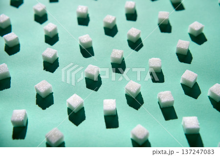 White sugar cubes pattern on green White sugar cubes pattern on green 137247083