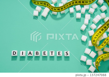 Diabetes concept with sugar and measuring tape 137247088