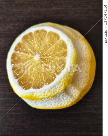 A close-up of a cut lemon, showing off its juicy flesh and bright yellow texture. 137247114