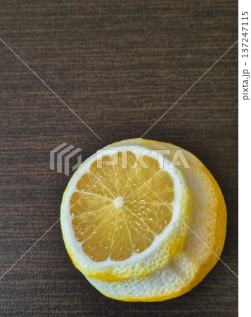 A close-up of a cut lemon, showing off its juicy flesh and bright yellow texture. 137247115