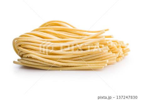 Fresh pasta ready for cooking, showing strands of bigoli set on a white background 137247830