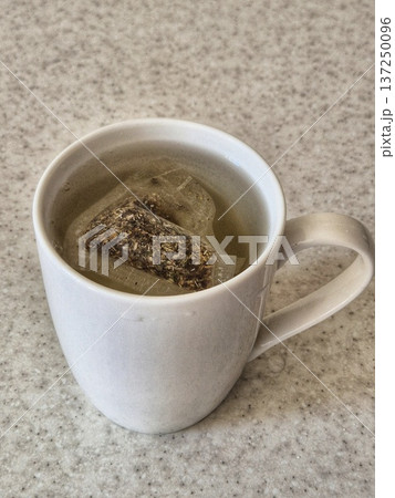 packaged herbal tea brewed in a cup 137250096