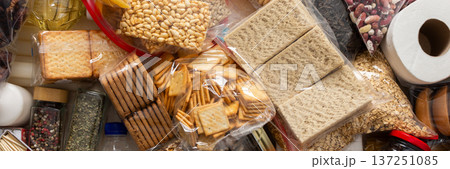 Essential home food stock for military operations and crises and for the period of quarantine and isolation, canned food, pasta, flour and nonperishable items,the concept of stay at home, banner 137251085