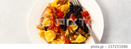 This wholesome breakfast includes black rice with stewed vegetables, stewed tomatoes, zucchini, peppers and onions top view This wholesome breakfast includes black rice with stewed vegetables, stewed tomatoes, zucchini, peppers and onions top view 137251086