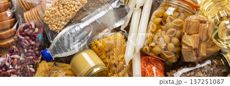 Essential home food stock for military operations and crises and for the period of quarantine and isolation, canned food, pasta, flour and nonperishable items,the concept of stay at home, banner 137251087