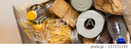 Canned goods, cereals, and pasta stored for quarantine and isolation, ensuring long-term survival and food security at home, survival during military operations, the concept of stay at home, banner 137251193