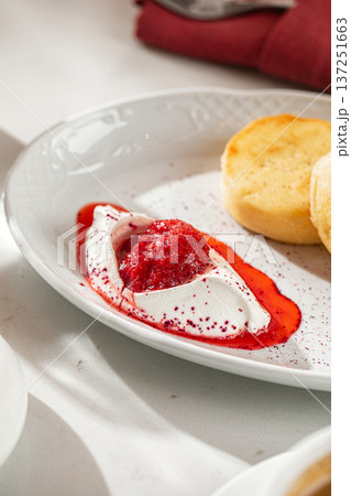 Syrniki with sour cream and berry jam 137251663