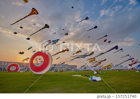 Doha, Qatar - January 20 2026: Qatar Kite Festival 2026 in Old Doha port (Mina District) sunset shot showing spectacular showcase of colorful kites Doha, Qatar - January 20 2026: Qatar Kite Festival 2026 in Old Doha port (Mina District) sunset shot showing spectacular showcase of colorful kites 137251740