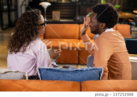 Professional woman talking with man posing during meeting in office interior Professional woman talking with man posing during meeting in office interior 137252986